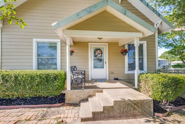 1009 W 7th St, Justin, TX 76247 - view of exterior entry featuring a porch and fence