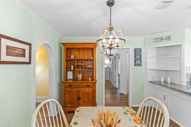 200 S Mimosa St, Paradise, TX 76073 - dining area featuring a chandelier, ornamental molding, arched walkways, wood finished floors, and baseboards