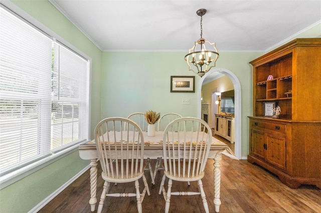 200 S Mimosa St, Paradise, TX 76073 - dining space with healthy amount of natural light, a chandelier, arched walkways, wood finished floors, and crown molding