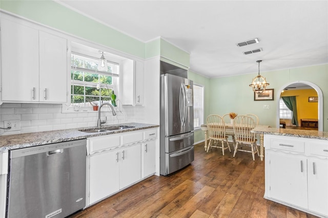 200 S Mimosa St, Paradise, TX 76073 - kitchen featuring stainless steel appliances, a sink, dark wood-style floors, white cabinetry, and backsplash
