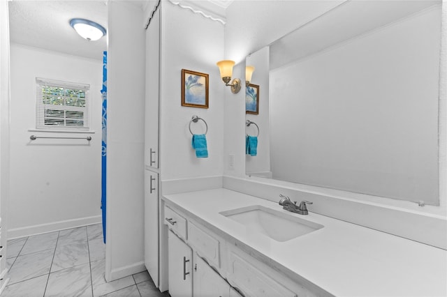 200 S Mimosa St, Paradise, TX 76073 - bathroom featuring marble look tile flooring, vanity, baseboards, and crown molding