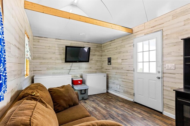 200 S Mimosa St, Paradise, TX 76073 - living room with wood walls, wood finished floors, vaulted ceiling, and baseboards