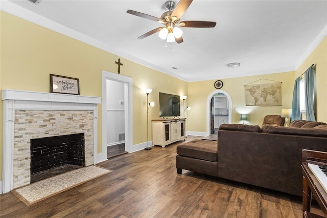 200 S Mimosa St, Paradise, TX 76073 - living room featuring a ceiling fan, wood-type flooring, a stone fireplace, baseboards, and ornamental molding