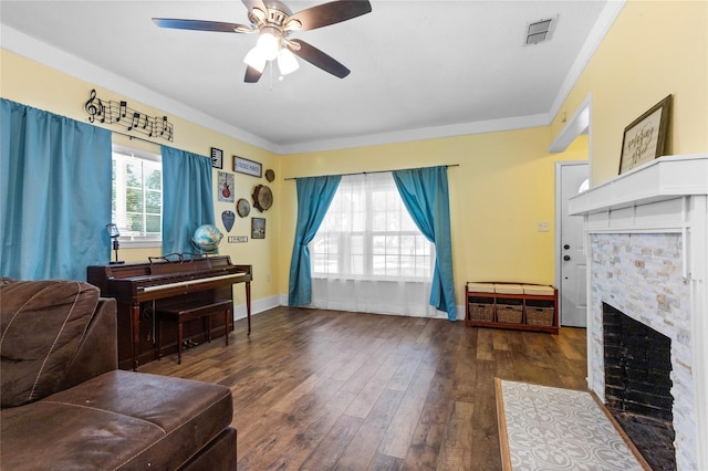200 S Mimosa St, Paradise, TX 76073 - living area featuring a fireplace with flush hearth, ceiling fan, hardwood / wood-style flooring, crown molding, and baseboards