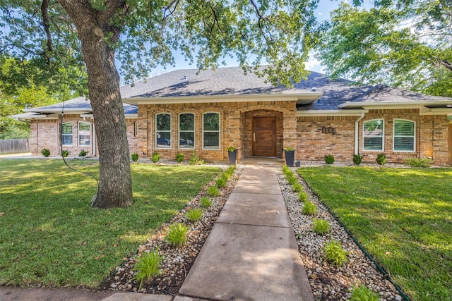 single story home with brick siding and a shingled roof