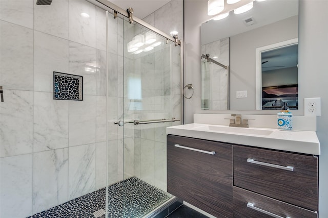 full bath with a stall shower, vanity, and ensuite bathroom