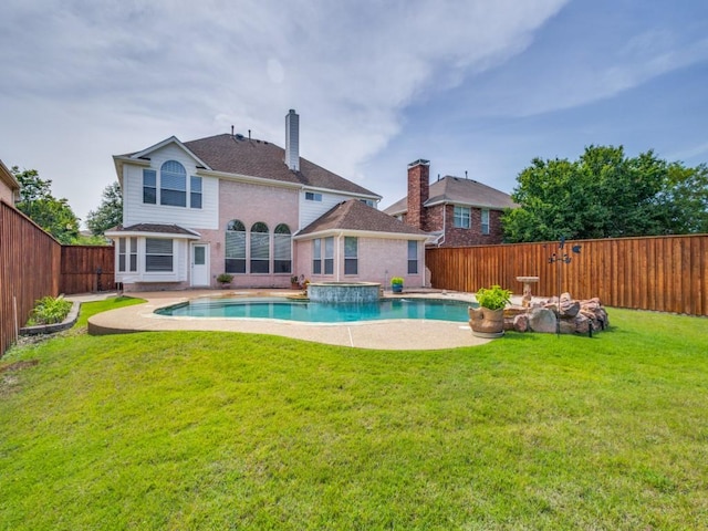 back of house with brick siding, a chimney, and a pool with connected hot tub