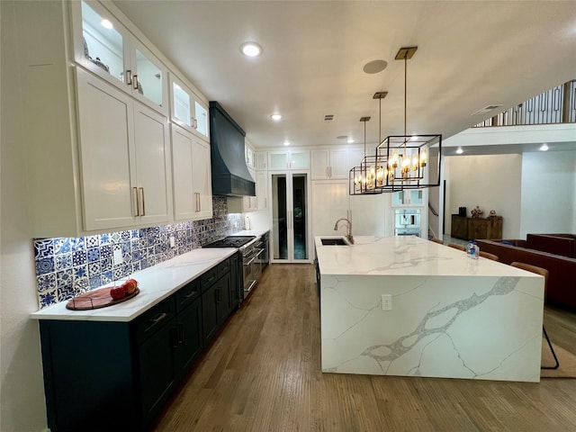 613 Wildcat Way, Kennedale, TX 76060 - kitchen with premium range hood, a sink, range with two ovens, dark cabinets, and white cabinets