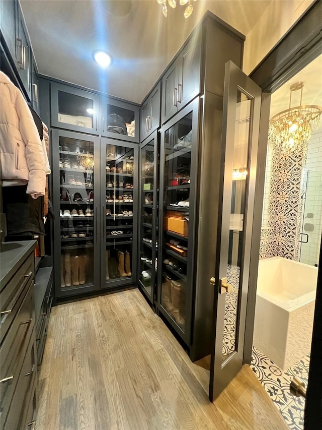 613 Wildcat Way, Kennedale, TX 76060 - wine area featuring a chandelier and light wood-style flooring