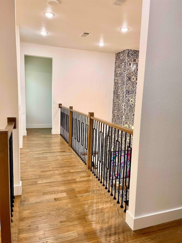 613 Wildcat Way, Kennedale, TX 76060 - hall with wood finished floors, baseboards, recessed lighting, and an upstairs landing