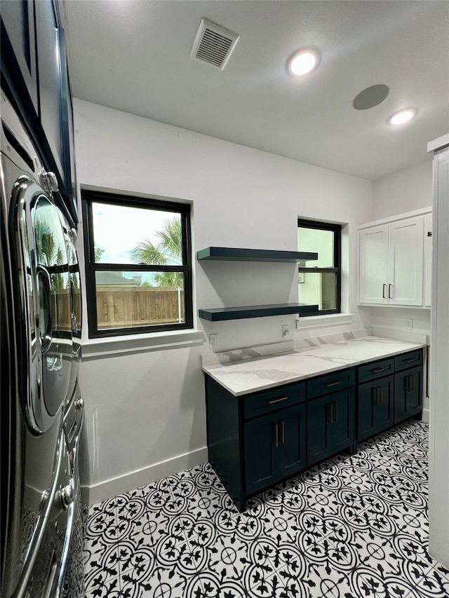 613 Wildcat Way, Kennedale, TX 76060 - laundry room featuring cabinet space, plenty of natural light, baseboards, recessed lighting, and washer and clothes dryer