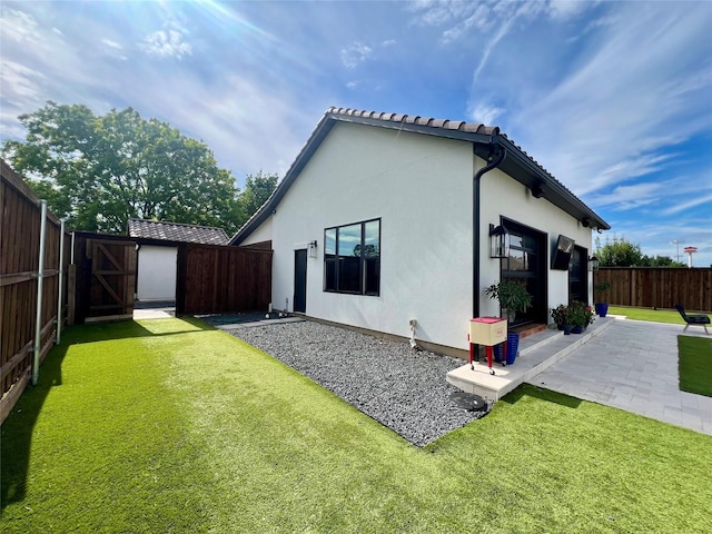 613 Wildcat Way, Kennedale, TX 76060 - back of house with a patio, stucco siding, a tiled roof, and a gate