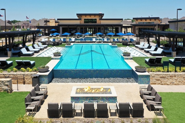 view of swimming pool featuring a fire pit