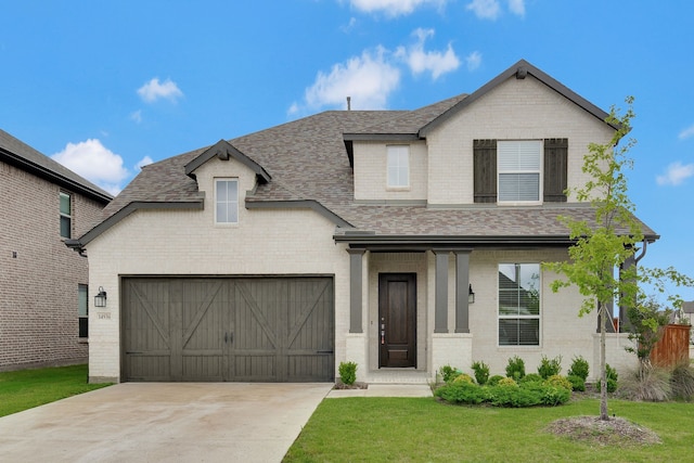 14936 Grissom Ave, Aledo, TX 76008 - view of front of home featuring a shingled roof, brick siding, a front yard, driveway, and a garage
