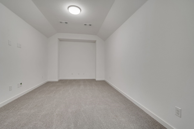 14936 Grissom Ave, Aledo, TX 76008 - empty room with light colored carpet, lofted ceiling, and baseboards