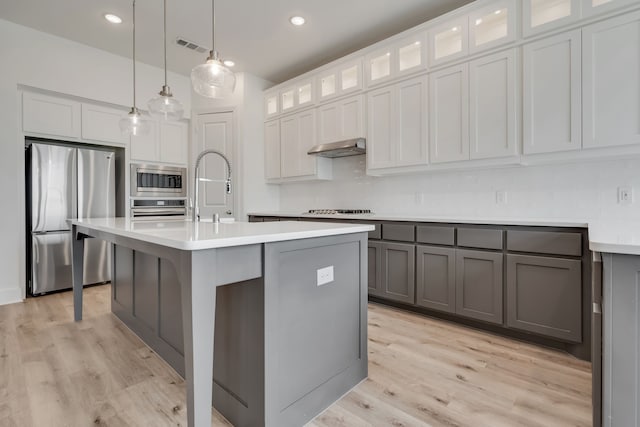 14936 Grissom Ave, Aledo, TX 76008 - kitchen featuring appliances with stainless steel finishes, light countertops, gray cabinets, light wood finished floors, and recessed lighting