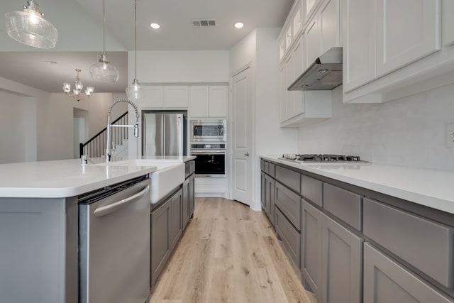14936 Grissom Ave, Aledo, TX 76008 - kitchen with stainless steel appliances, range hood, gray cabinetry, light wood-type flooring, and recessed lighting