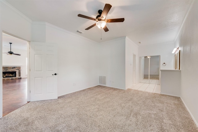 8525 Creekview Dr, Frisco, TX 75034 - unfurnished room with ceiling fan, carpet floors, ornamental molding, a brick fireplace, and baseboards