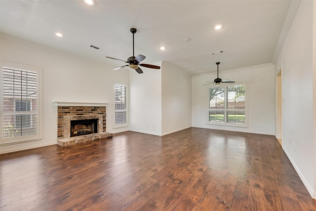8525 Creekview Dr, Frisco, TX 75034 - unfurnished living room featuring ceiling fan, dark wood-style flooring, ornamental molding, recessed lighting, and a brick fireplace