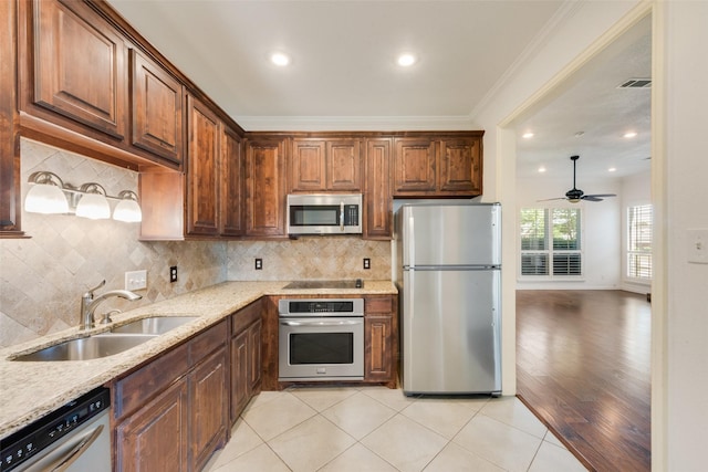 8525 Creekview Dr, Frisco, TX 75034 - kitchen with appliances with stainless steel finishes, a sink, light stone countertops, decorative backsplash, and recessed lighting