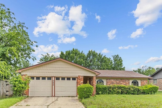 ranch-style house with an attached garage, concrete driveway, brick siding, and a front lawn
