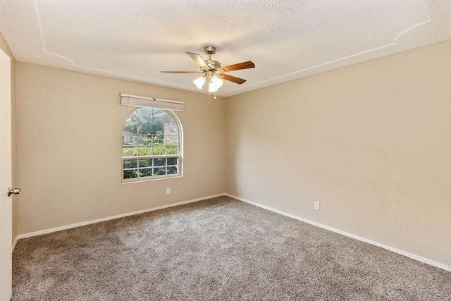 empty room with ceiling fan, carpet floors, a textured ceiling, and baseboards