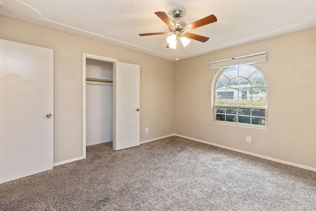 unfurnished bedroom with carpet, a closet, and baseboards