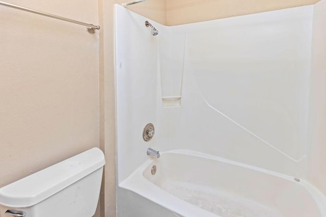 full bathroom featuring toilet and  shower combination
