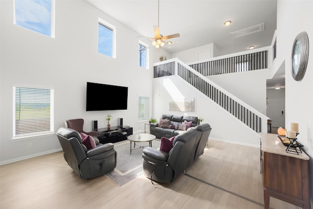 2040 Hartley Dr, Forney, TX 75126 - living area with wood finished floors, a high ceiling, stairway, baseboards, and ceiling fan