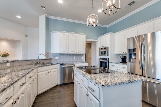 2401 Greenwich Dr, Carrollton, TX 75006 - kitchen featuring stainless steel appliances, a chandelier, crown molding, a sink, and tasteful backsplash