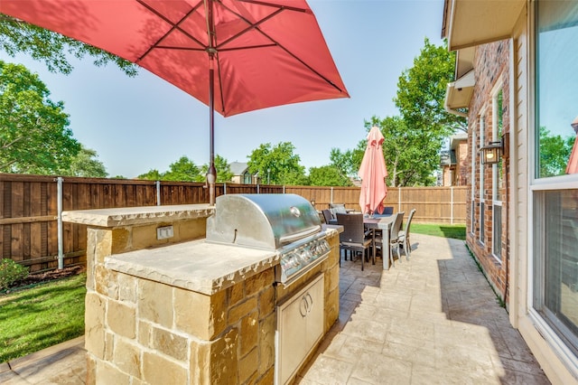 2401 Greenwich Dr, Carrollton, TX 75006 - view of patio featuring an outdoor kitchen, outdoor dining area, area for grilling, and a fenced backyard