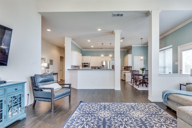 2401 Greenwich Dr, Carrollton, TX 75006 - living room featuring dark wood-style floors, crown molding, baseboards, recessed lighting, and a chandelier