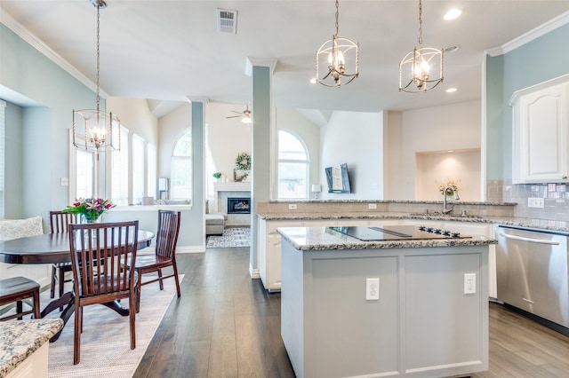2401 Greenwich Dr, Carrollton, TX 75006 - kitchen with a chandelier, black electric cooktop, dishwasher, ornamental molding, and tasteful backsplash