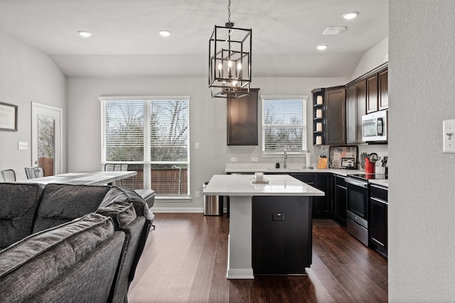 10116 Mickler Ln, Waco, TX 76708 - kitchen featuring stainless steel appliances, a chandelier, dark wood-type flooring, lofted ceiling, and light countertops