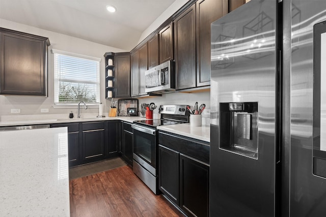 10116 Mickler Ln, Waco, TX 76708 - kitchen featuring stainless steel appliances, a sink, recessed lighting, dark wood-type flooring, and dark brown cabinets