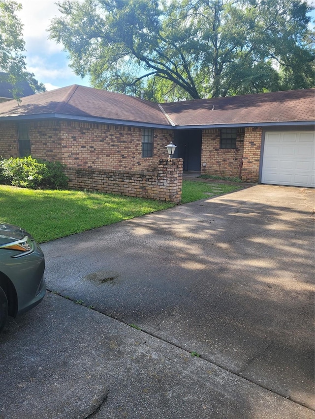 6313 Westwood Rd, Shreveport, LA 71129 - view of side of home featuring brick siding, driveway, a lawn, and a garage
