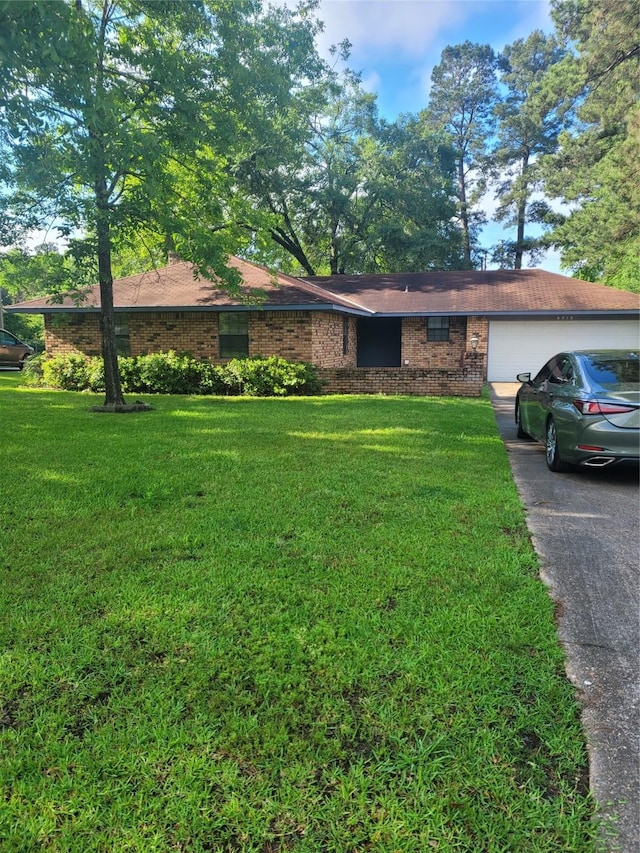 6313 Westwood Rd, Shreveport, LA 71129 - ranch-style home with concrete driveway, brick siding, a garage, and a front lawn