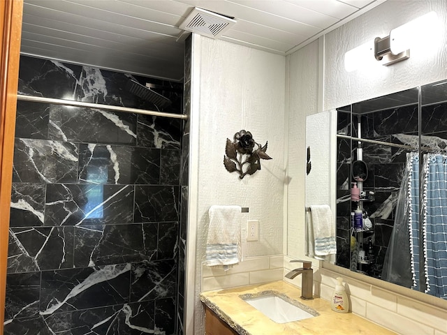 1075 County Road 32240, Sumner, TX 75486 - bathroom featuring a shower, a textured wall, and vanity