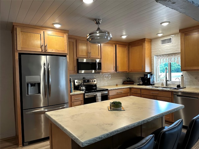 1075 County Road 32240, Sumner, TX 75486 - kitchen with appliances with stainless steel finishes, a breakfast bar area, light countertops, decorative backsplash, and recessed lighting