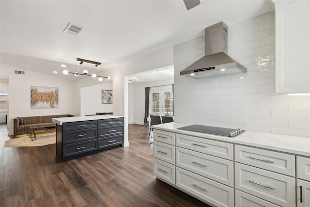 10834 Wyatt St, Dallas, TX 75218 - kitchen with wall chimney exhaust hood, decorative backsplash, dark wood finished floors, black electric cooktop, and open floor plan
