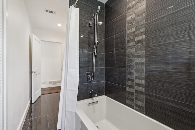 10834 Wyatt St, Dallas, TX 75218 - bathroom featuring shower / bath combo and baseboards
