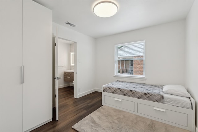 10834 Wyatt St, Dallas, TX 75218 - bedroom featuring dark wood-type flooring and baseboards