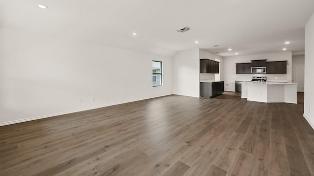 440 Drake Dr, Ferris, TX 75125 - unfurnished living room with recessed lighting and dark wood-type flooring