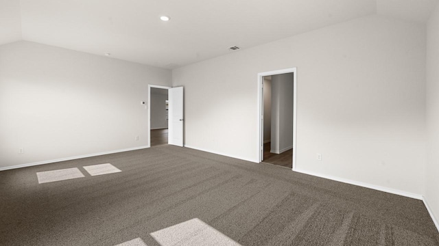 440 Drake Dr, Ferris, TX 75125 - empty room with vaulted ceiling, dark colored carpet, and recessed lighting