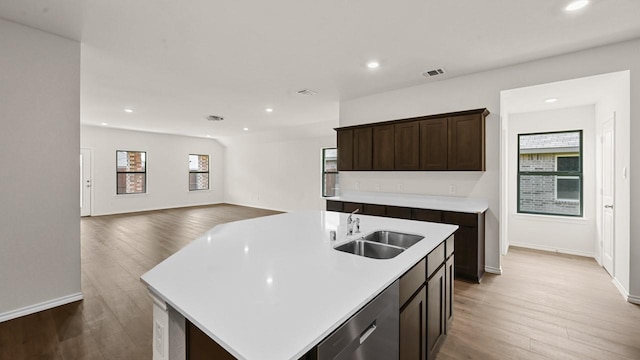 440 Drake Dr, Ferris, TX 75125 - kitchen with stainless steel dishwasher, wood finished floors, light countertops, recessed lighting, and dark brown cabinets