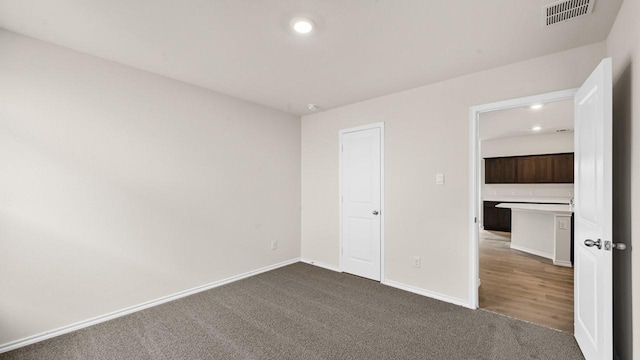 440 Drake Dr, Ferris, TX 75125 - unfurnished bedroom with dark carpet and recessed lighting