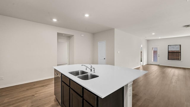 440 Drake Dr, Ferris, TX 75125 - kitchen featuring dishwasher, wood finished floors, light countertops, a center island with sink, and recessed lighting