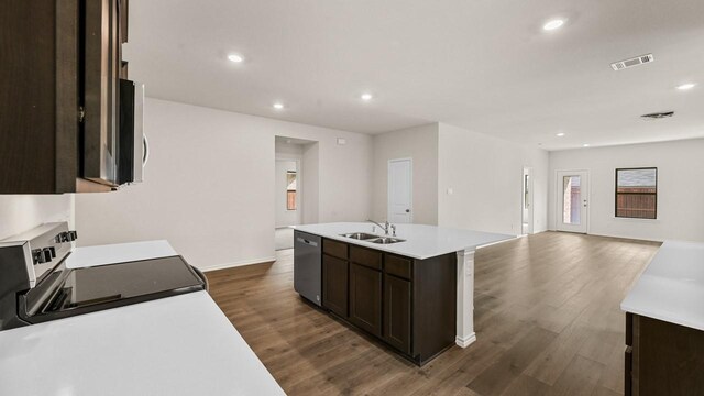 440 Drake Dr, Ferris, TX 75125 - kitchen with stainless steel appliances, dark wood-style floors, dark brown cabinetry, light countertops, and open floor plan