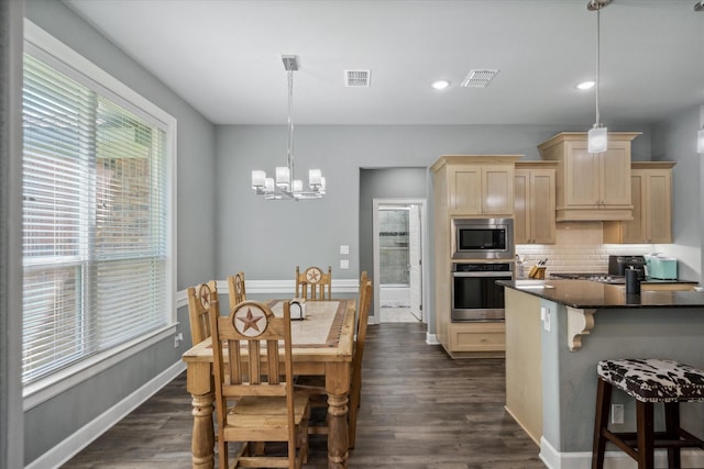 2231 Rana Park, Flint, TX 75762 - kitchen featuring stainless steel appliances, light brown cabinetry, decorative backsplash, dark countertops, and a breakfast bar area