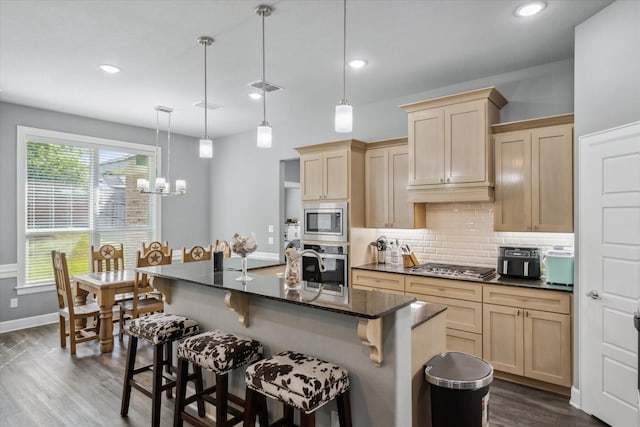 2231 Rana Park, Flint, TX 75762 - kitchen with stainless steel appliances, tasteful backsplash, dark wood finished floors, baseboards, and a kitchen bar
